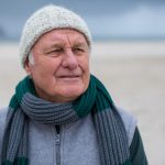 Senior man standing on the beach
